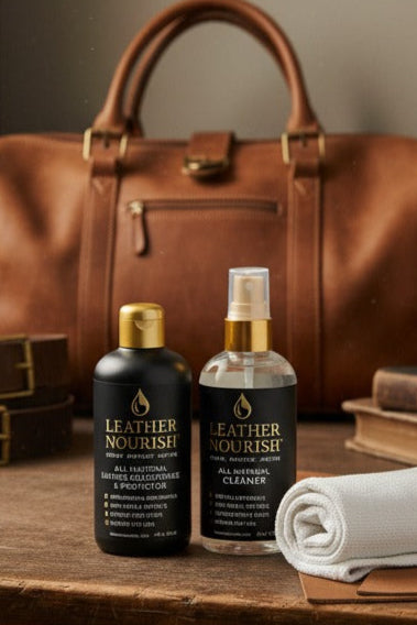 Leather care products and accessories on a wooden surface with a leather bag and boots in the background.